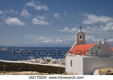 Church overlooking cityscape and ocean, Mykonos, Cyclades Islands, Greece View Large Photo Image Picture - Church overlooking cityscape and ocean, Mykonos, Cyclades Islands, Greece. Fotosearch