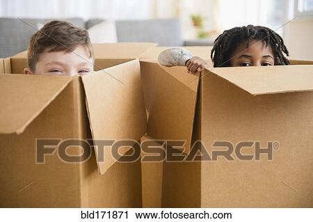 Close up of boys playing in cardboard boxes View Large Photo Image Stock Image - Close up of boys playing in cardboard boxes. Fotosearch