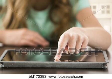 Stock Image - Close up of Caucasian girl using digital tablet. Fotosearch