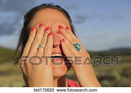 Close up of Caucasian woman covering her eyes View Large Photo Image Stock Image - Close up of Caucasian woman covering her eyes. Fotosearch