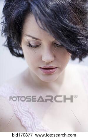 Close up of Caucasian woman looking down View Large Photo Image Stock Photo - Close up of Caucasian woman looking down. Fotosearch