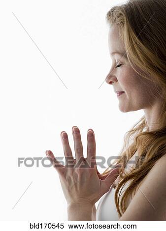 Stock Photography - Close up of Caucasian woman meditating. Fotosearch