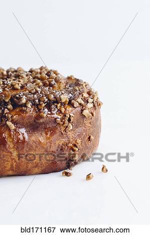 Close up of cinnamon roll with nuts View Large Photo Image Stock Photo - Close up of cinnamon roll with nuts. Fotosearch