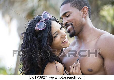 Close up of couple hugging outdoors View Large Photo Image Stock Photo - Close up of couple hugging outdoors. Fotosearch