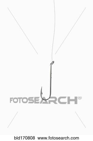 Stock Photo - Close up of dangling fishing hook. Fotosearch