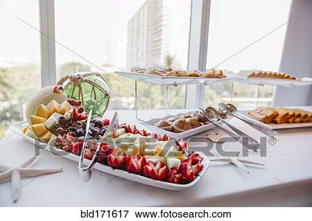 Stock Photo - Close up of fruit and muffins at breakfast buffet. Fotosearch