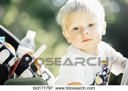 Close up of mixed race boy sitting in stroller View Large Photo Image Stock Photo - Close up of mixed race boy sitting in stroller. Fotosearch