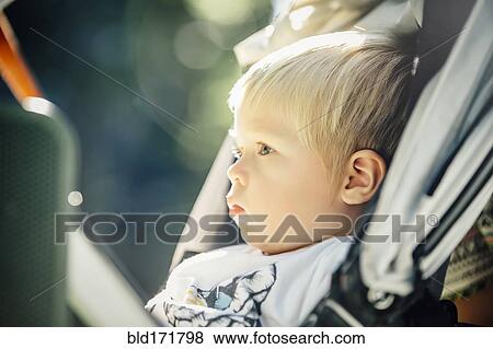 Close up of mixed race boy sitting in stroller View Large Photo Image Stock Photo - Close up of mixed race boy sitting in stroller. Fotosearch