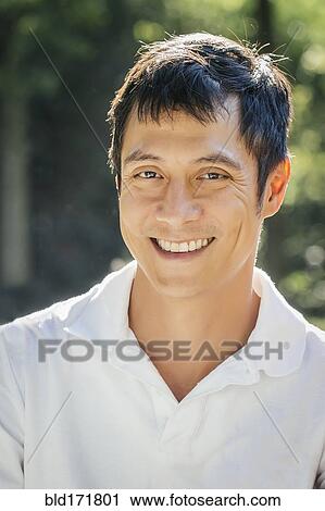 Stock Image - Close up of mixed race man smiling. Fotosearch