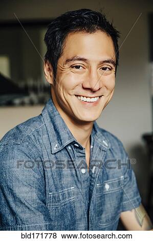 Stock Photo - Close up of mixed race man smiling. Fotosearch