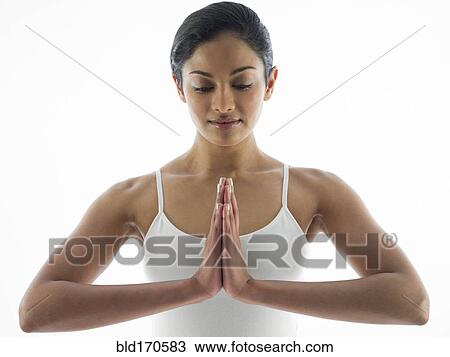 Stock Image - Close up of serene woman meditating. Fotosearch