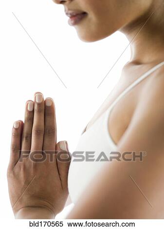 Close up of serene woman meditating with hands clasped View Large Photo Image Stock Photography - Close up of serene woman meditating with hands clasped. Fotosearch