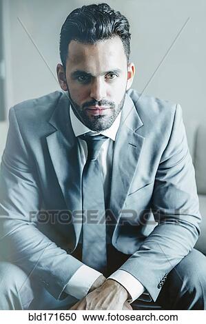 Close up of serious businessman sitting View Large Photo Image Stock Image - Close up of serious businessman sitting. Fotosearch