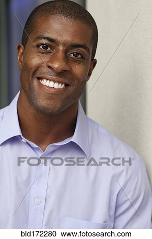 Stock Image - Close up of smiling Black businessman. Fotosearch