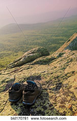 Close up of sneakers on rocky hilltop in remote landscape View Large Photo Image Stock Image - Close up of sneakers on rocky hilltop in remote landscape. Fotosearch