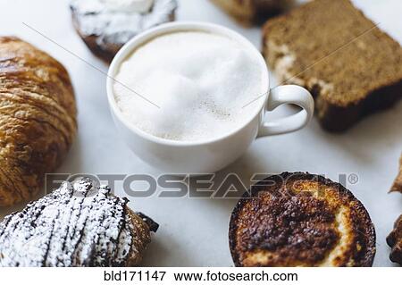 Close up of variety of pastries and coffee View Large Photo Image Stock Photo - Close up of variety of pastries and coffee. Fotosearch