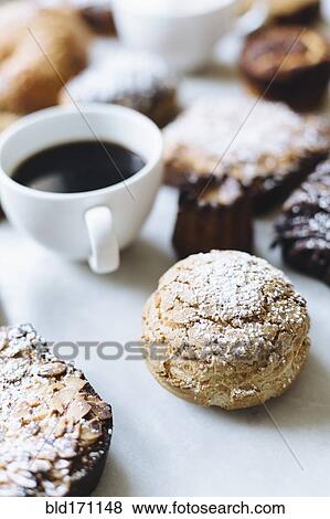 Close up of variety of pastries and coffee View Large Photo Image Stock Photo - Close up of variety of pastries and coffee. Fotosearch