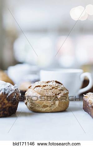 Close up of variety of pastries and coffee View Large Photo Image Stock Photograph - Close up of variety of pastries and coffee. Fotosearch