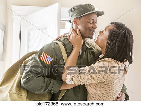 Close up of woman kissing returning soldier View Large Photo Image Stock Photo - Close up of woman kissing returning soldier. Fotosearch