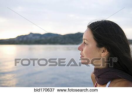 Stock Photo - Close up of woman overlooking ocean. Fotosearch