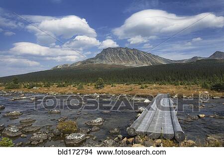 Concrete footbridge over river in remote landscape View Large Photo Image Picture - Concrete footbridge over river in remote landscape. Fotosearch