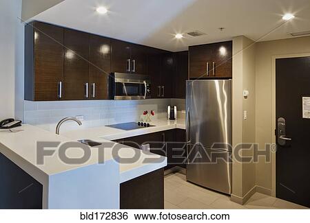 Stock Photograph - Counters and cabinets in modern kitchen. Fotosearch