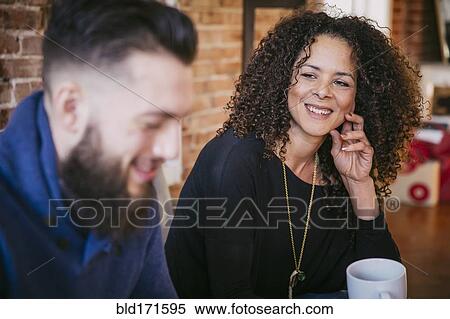 Couple drinking coffee in living room View Large Photo Image Stock Photography - Couple drinking coffee in living room. Fotosearch