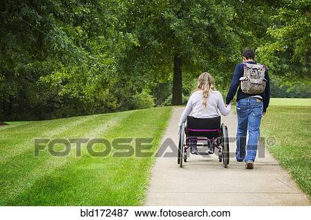 Stock Photo - Couple holding hands in park. Fotosearch