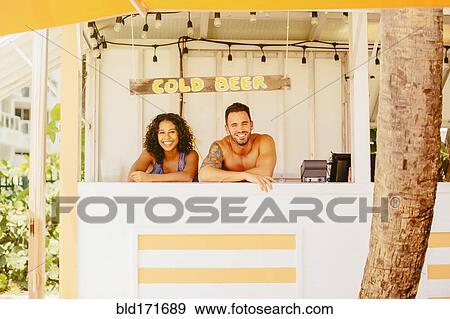 Stock Photo - Couple leaning in beach shack. Fotosearch