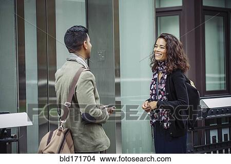 Picture - Couple talking in city. Fotosearch