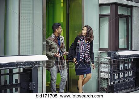 Stock Photography - Couple talking in city. Fotosearch