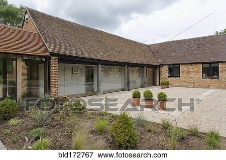 Stock Photo - Courtyard of converted barn home. Fotosearch