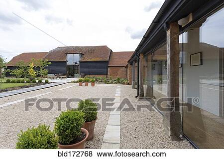 Stock Photo - Courtyard of converted barn home. Fotosearch