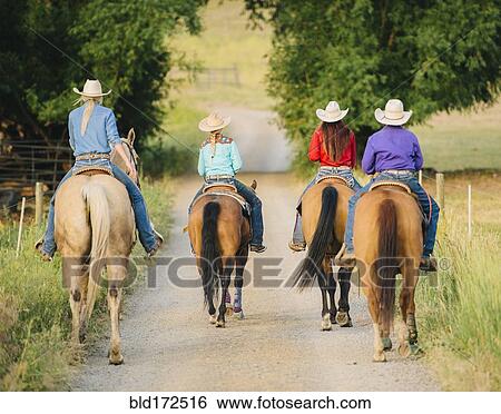 Cowgirls and cowboy riding horses in rural road View Large Photo Image Stock Photograph - Cowgirls and cowboy riding horses in rural road. Fotosearch