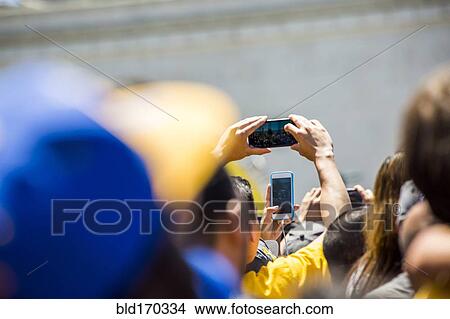 Picture - Crowd of fans photographing sporting event. Fotosearch