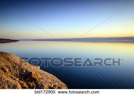 Stock Photography - Dead Sea reflecting sunset sky, Al Karak, Jordan. Fotosearch