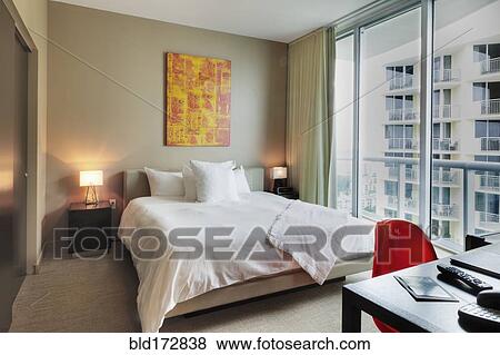 Stock Photo - Desk and bed in hotel room. Fotosearch