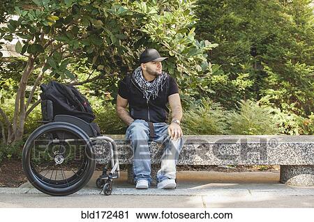 Disabled man and wheelchair sitting on stone bench View Large Photo Image Stock Image - Disabled man and wheelchair sitting on stone bench. Fotosearch