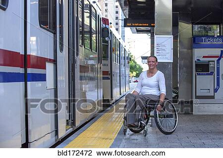 Disabled woman in wheelchair waiting in train station View Large Photo Image Stock Image - Disabled woman in wheelchair waiting in train station. Fotosearch