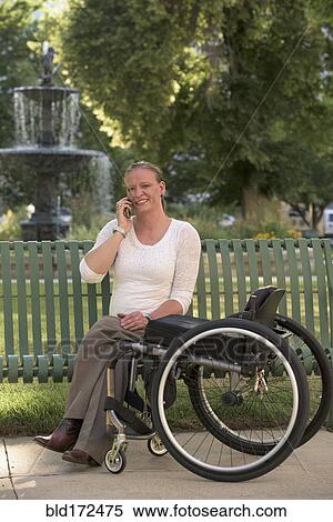Disabled woman with wheelchair sitting on bench View Large Photo Image Stock Photography - Disabled woman with wheelchair sitting on bench. Fotosearch