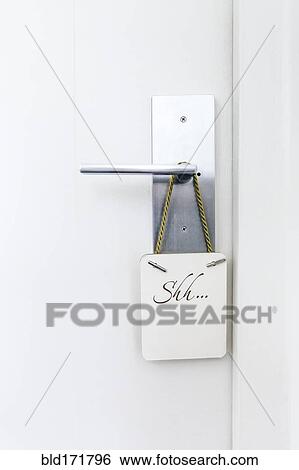 Stock Photograph - Do not disturb sign on hotel room doorknob. Fotosearch