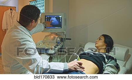 Doctor using ultrasound on pregnant woman View Large Photo Image Stock Image - Doctor using ultrasound on pregnant woman. Fotosearch