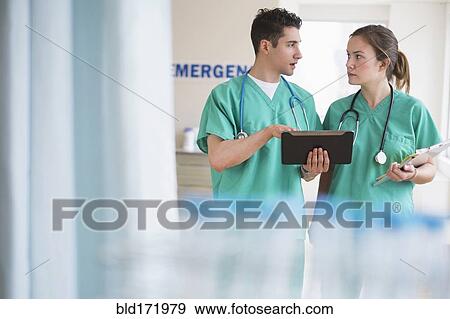 Stock Photo - Doctors talking in hospital emergency room. Fotosearch