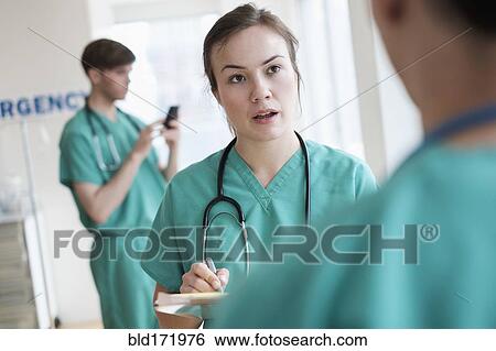 Stock Photograph - Doctors talking in hospital emergency room. Fotosearch