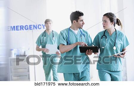 Stock Photography - Doctors talking in hospital emergency room. Fotosearch