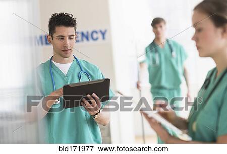 Doctors working in hospital emergency room View Large Photo Image Stock Photo - Doctors working in hospital emergency room. Fotosearch