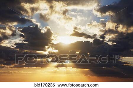 Dramatic clouds in sunset sky View Large Photo Image Stock Photography - Dramatic clouds in sunset sky. Fotosearch