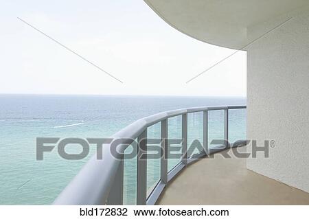 Stock Image - Empty balcony overlooking ocean. Fotosearch