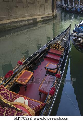 Stock Image - Empty gondola sailing on Venice canal, Veneto, Italy. Fotosearch