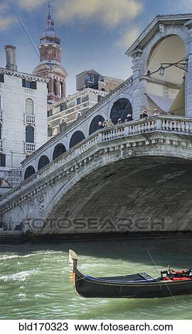 Stock Image - Empty gondola sailing on Venice canal, Veneto, Italy. Fotosearch